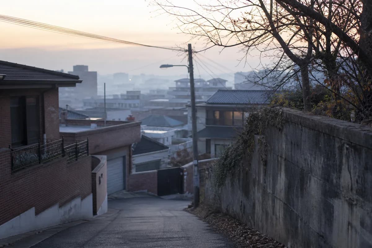 대운 바뀌는 시기의 전환감을 담은 사진으로, 안개가 낮게 깔린 이른 새벽 한국 주택가 골목이 비어 있는 모습